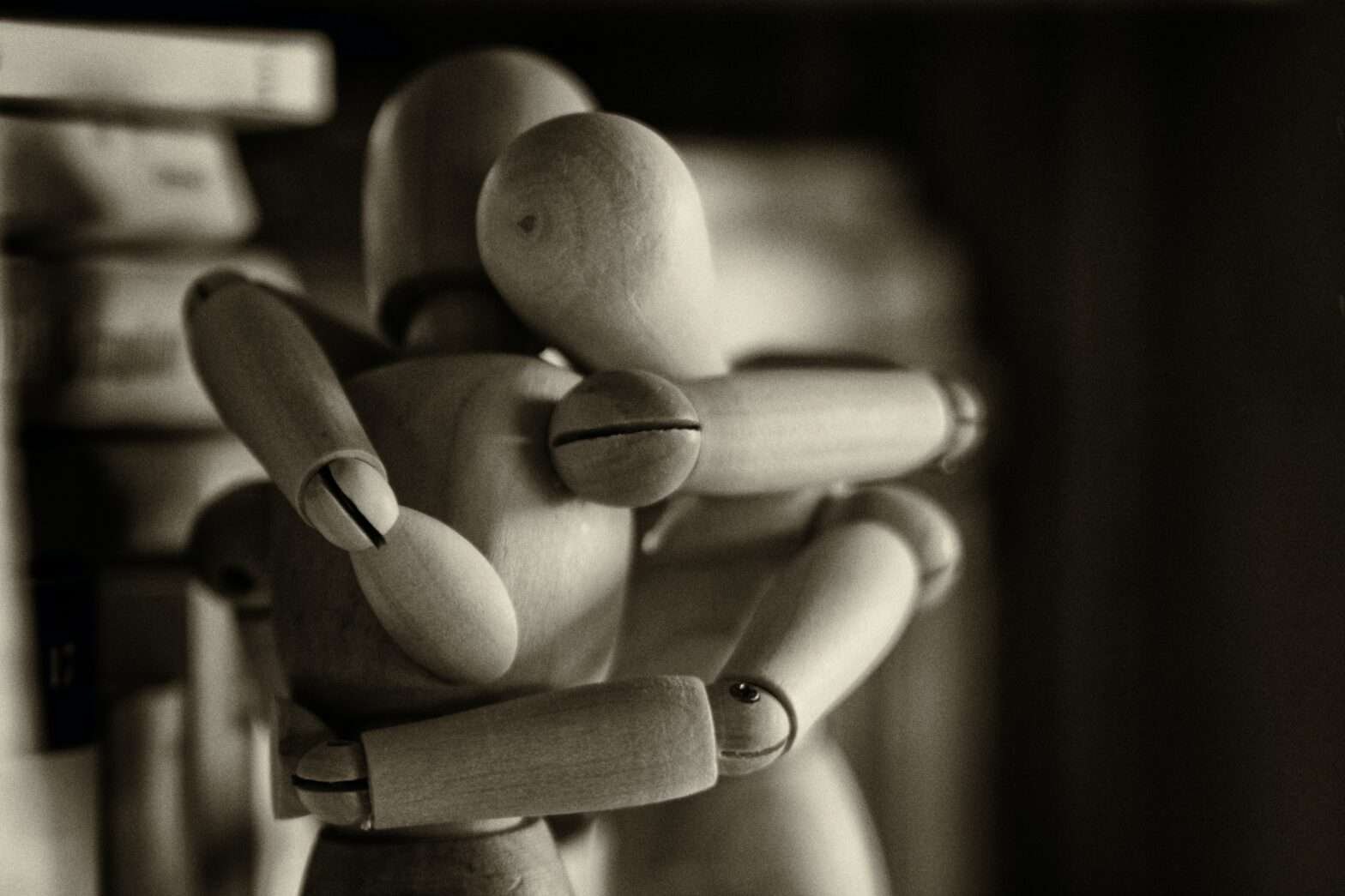 Dois bonecos de madeira se abraçando