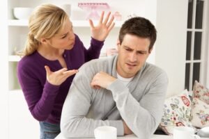 Um homem sentado à mesa quando sua esposa reclama de uma amizade inadequada