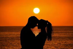 Silhueta de um casal namorando ao pôr-do-sol